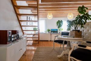 a living room with a table and a kitchen at Artist Loft in Corfu
