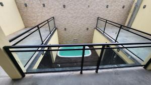 an image of a glass staircase in a building at Espaço Frente ao Lago in Trindade