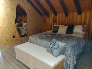 a bedroom with two beds and a mirror at Vale do Vento Inn in Farroupilha