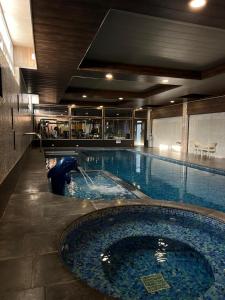 a large swimming pool with a water fountain at alamari gardens in Irbid
