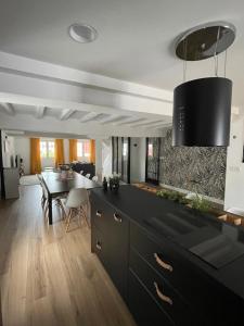 a kitchen with a table and a dining room at Belle Maison Basque 10 Personnes in Urrugne