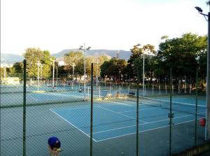 a group of tennis courts with people on them at Acogedora Habitación Privada - Belén Rosales Laureles in Medellín