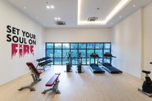 a gym with treadmills and exercise equipment in a room at 3volution Stays in Petaling Jaya