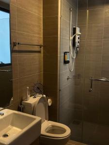 a bathroom with a shower and a toilet and a sink at 3volution Stays in Petaling Jaya