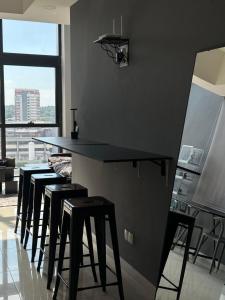 a group of stools in a kitchen with a counter at 3volution Stays in Petaling Jaya +11 photos