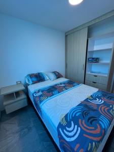 a bedroom with a bed with a blue light at Apartamento Lujoso Yumbo in Arroyo Hondo +13 photos