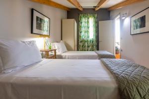 a bedroom with two beds and a window at Artist Loft in Corfu