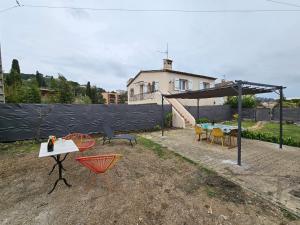 a patio with a table and chairs and a canopy at Au Farniente in Vallauris
