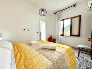 a bedroom with a large bed and a window at Bellevue Vacation Room in Bari Sardo