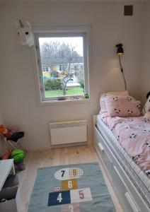 a small bedroom with a bed and a window at summer house near Malmköping - Södermanland in Malmköping +79 photos