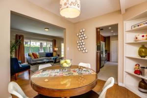 a dining room and living room with a table and chairs at Kiwi Cottage Permit# 992 in Palm Springs