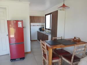a kitchen with a red refrigerator and a table at Casa Interior en La Cruz Quillota in Quillota