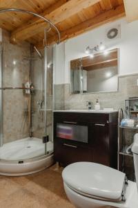 a bathroom with a tub and a toilet and a sink at La Casina de Maxa in Suares +24 photos