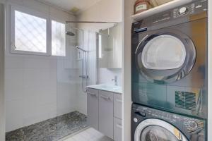 a washing machine in a bathroom with a sink at Maison Papavero in La Teste-de-Buch +9 photos