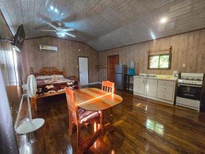 a kitchen and dining room with a table and a ceiling fan at Hibiscus Cabin with AC at Freshwater Creek Cabanas in Hopkins