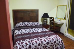 Postel nebo postele na pokoji v ubytování Hotel Topacio