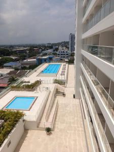 a view of the pool from the balcony of a building at Cartagena Beach Resort 807 in Cartagena de Indias