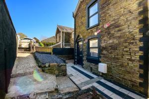 a brick building with a door on the side of it at Local City Centre 3 Bedroom House in Clydach