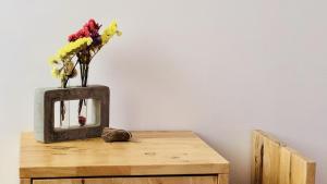 a vase of flowers sitting on top of a wooden table at The Dream in Massa Lubrense