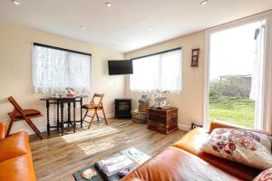 a living room with a couch and a table at Two Hoots Chalet in Mundesley