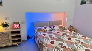 a bedroom with a bed and a blue wall at The Dream in Massa Lubrense