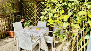 a table and chairs on a patio next to a tree at The Dream in Massa Lubrense