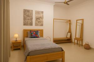 a bedroom with a bed and a mirror at Comfortable 4BDR Villa for Families or Groups East Airport Spintex in Accra