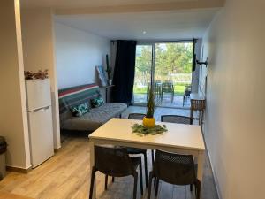 a kitchen and living room with a table and chairs at New apartment, mountain view in Espelette