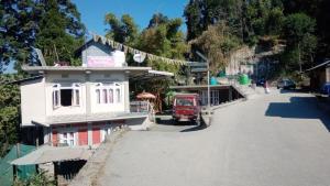 a red truck parked on the side of a road at Yellow Bamboo Homestay in Mangpu