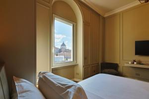 a bedroom with a window with a view of the city at Residenza Alferini - San Pietro in Rome