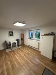 an empty living room with a table and chairs at Zentrales & ruhiges Appartment in Schwäbisch Hall