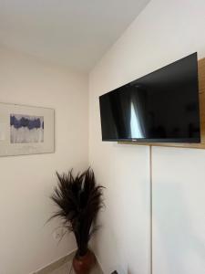 a living room with a flat screen tv on a wall at St Pasha in Paillé