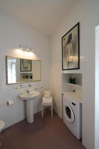 a bathroom with a sink and a washing machine at Il Cortile di San Rufino in Assisi +49 photos