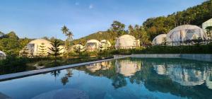 a group of domes at a resort with a swimming pool at Sunny Side Resort Koh Tao in Ko Tao