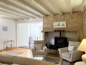 a living room with a couch and a fireplace at Domaine La Buissière Duravel "La Maison" Piscine privative in Duravel