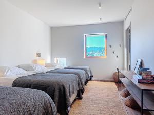 a group of four beds in a room at Villas Inamorata in Lecci