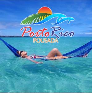 a woman laying in a hammock in the water at Porto Rico - Hotesol in Porto De Galinhas