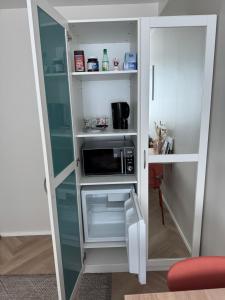 a small refrigerator with a microwave inside of it at Short stay in the city center, free parking in Tampere