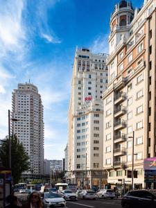 a group of tall buildings on a city street at Casa Debod in Madrid