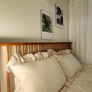 a bed with two pillows on top of it at Lala Stay in Seoul +31 photos