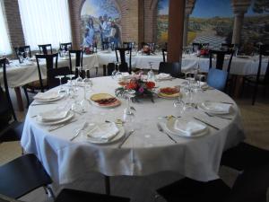 a table with plates of food and wine glasses at Domus Viatoris in Sahagún