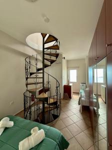 a bedroom with a spiral staircase in a room at SyrasView in Ermoupoli