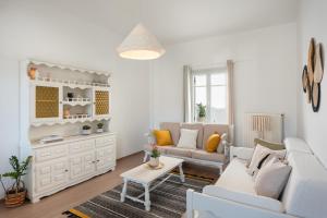 a living room with a couch and a table at Citrine in Naousa