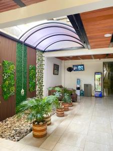 a lobby with potted plants in a building at Daresff Imperial in Puerto Wilches +14 photos
