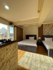 Ένα ή περισσότερα κρεβάτια σε δωμάτιο στο Cheops Pyramids Inn