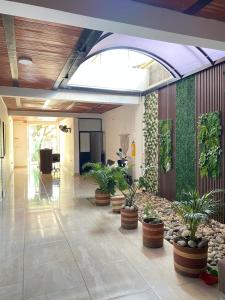 a lobby with potted plants in a building at Daresff Imperial in Puerto Wilches