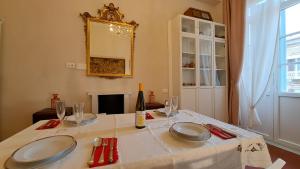 a table with plates and glasses and a bottle of wine at CAVOUR257 in La Spezia