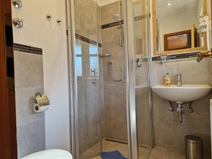 a bathroom with a shower and a sink at Pension Aufeld in Landsberg am Lech +18 photos
