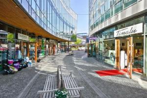 an empty street in a city with buildings at Villa Central in Asker