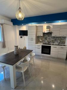 a kitchen with a table and chairs in a room at Terrasini Sea in Terrasini